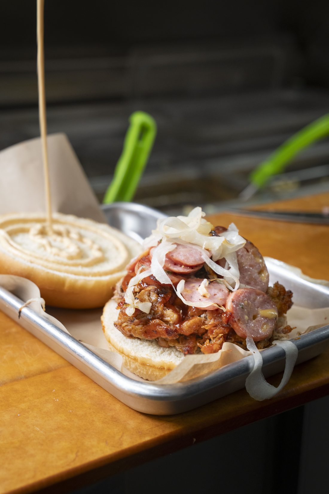 Alabama-Slamma — Smoked chicken, Alabama white sauce, crisp slaw, brioche bun.