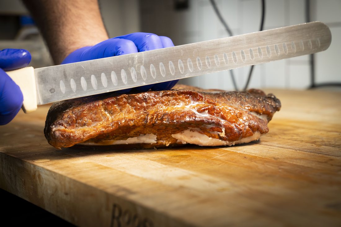 Beef Brisket — Pecan-wood smoked for 12+ hours. Hand-sliced to order. Sold by the half pound. Comes with two slices of bread and pickles.