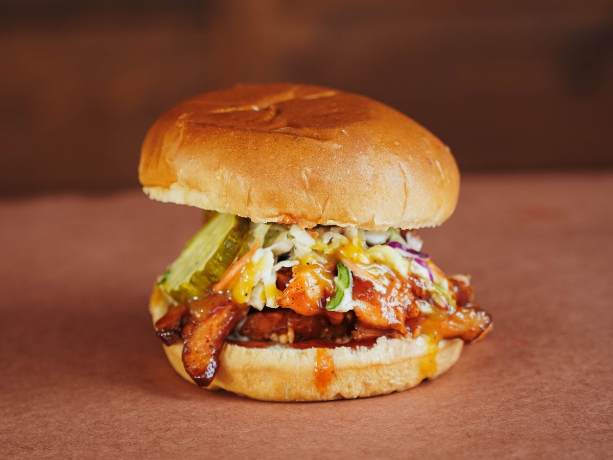 Carolina — Pulled pork or smoked chicken with sweet & tangy BBQ, topped with coleslaw, pickles, and Carolina mustard.