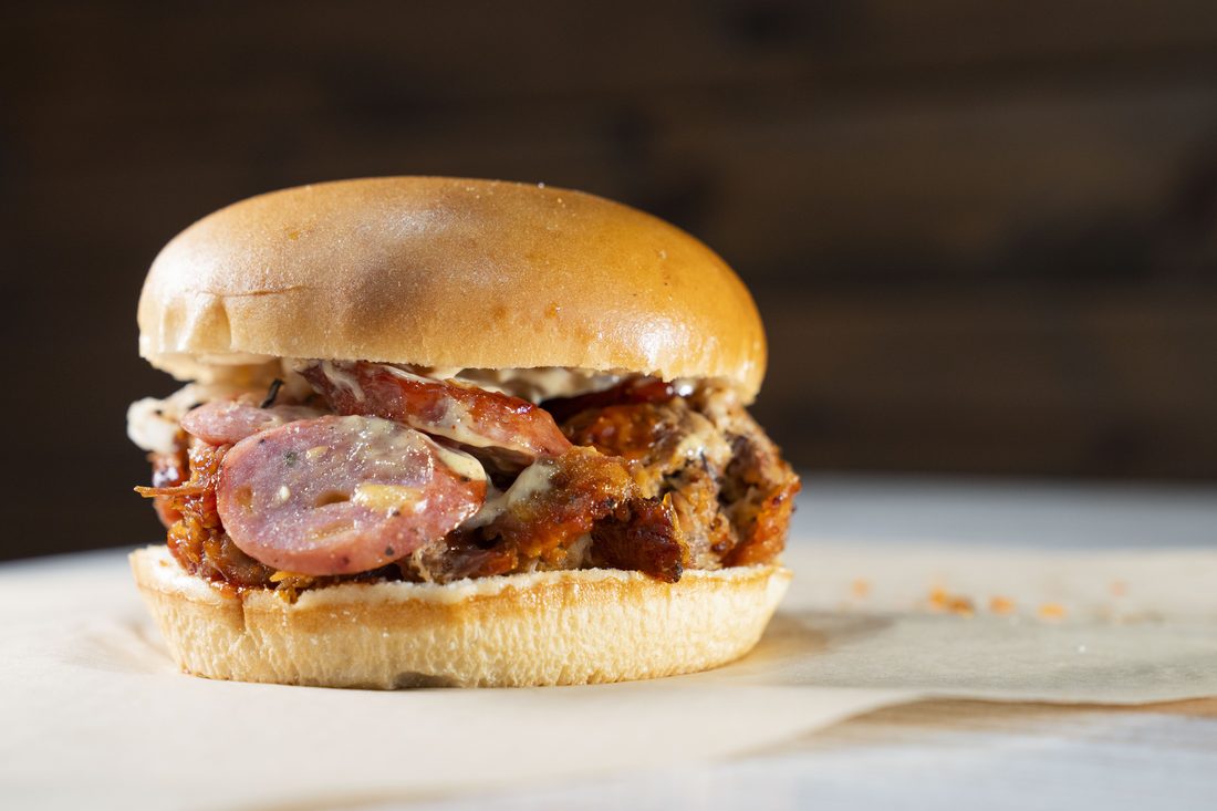 Smoked Chicken (½) — Half chicken, dry-rubbed and pecan-wood smoked. Crisp skin, juicy interior, your choice of sauce.