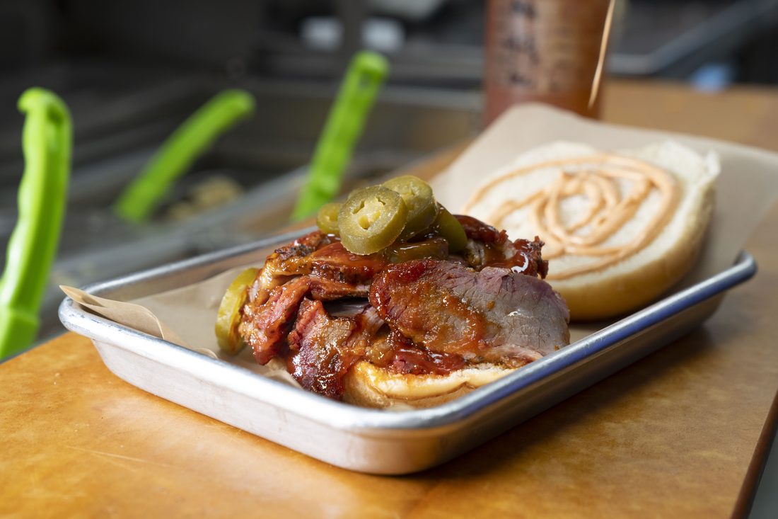 Hot Texan — Brisket, pepper-jack, jalapeños, chipotle aioli, toasted hoagie.