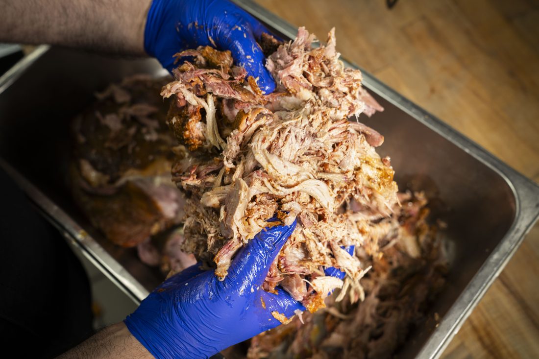 Pulled Pork Plate — Slow-smoked pork shoulder, hand-pulled, served with two sides, Texas toast, and pickles. Choice of sauce.