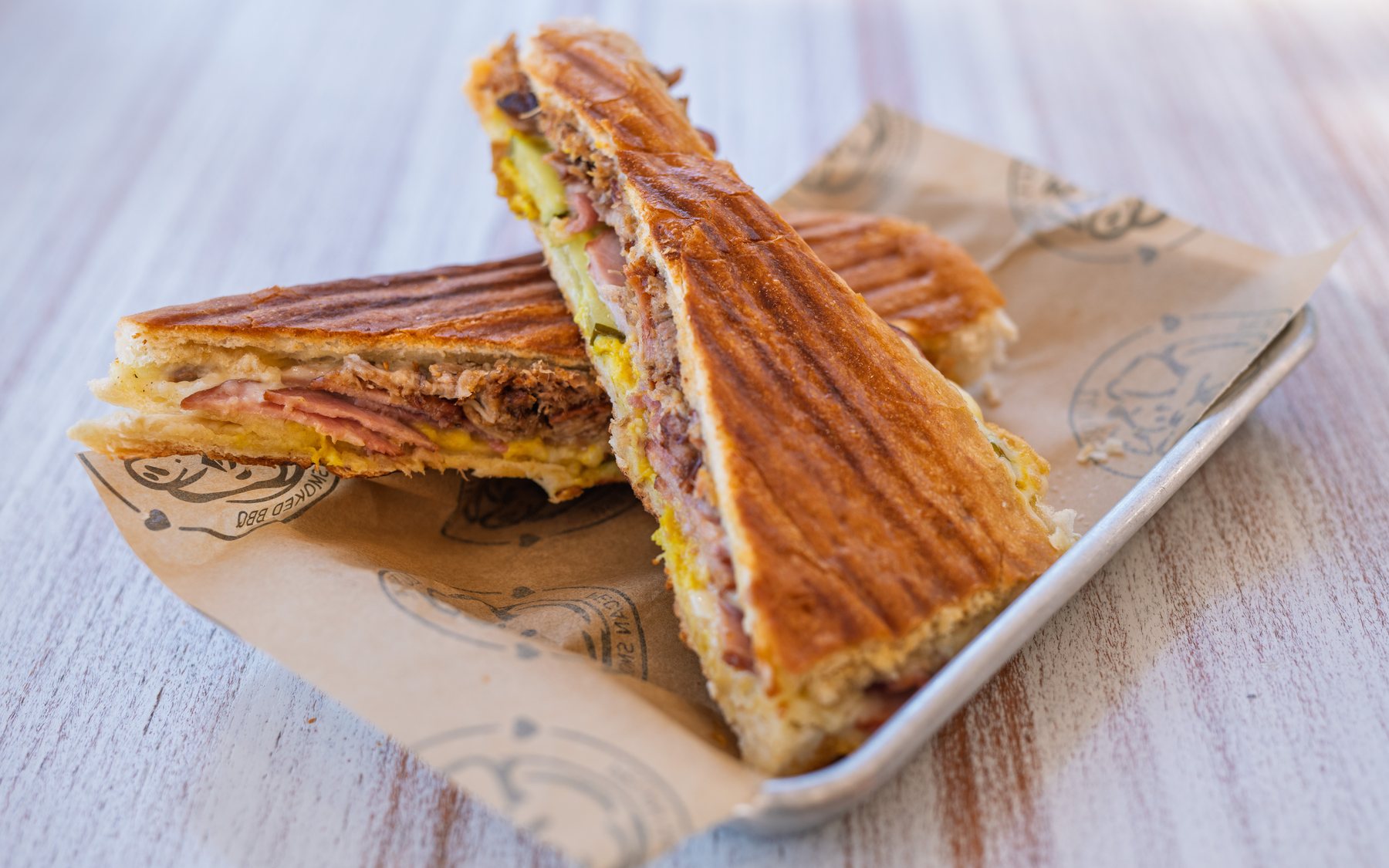 Southern Luv BBQ's award-winning Cuban sandwich, pressed on Cuban bread with pecan-smoked pork, ham, Swiss and pickles