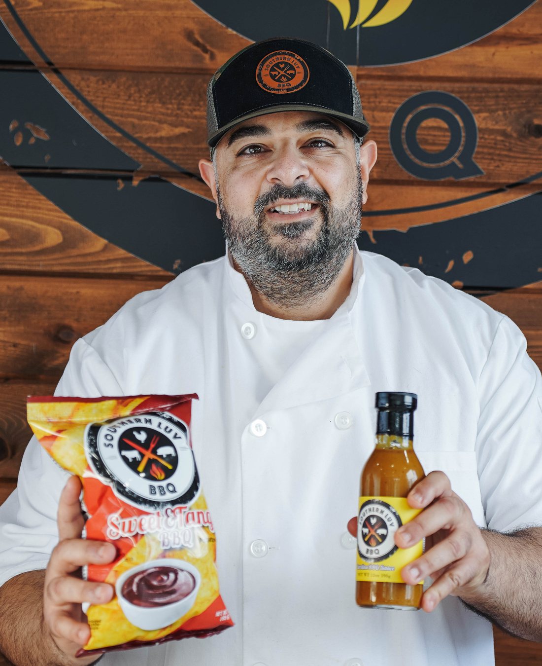Chef Essi Tadrus holding Southern Luv chips and BBQ sauce